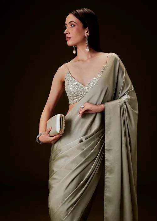 Mint Green Saree With Tassel Embellished Pallu And Deep V Neck Sleeveless Blouse
