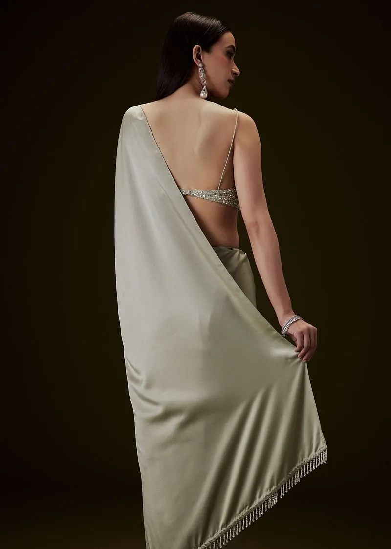 Mint Green Saree With Tassel Embellished Pallu And Deep V Neck Sleeveless Blouse