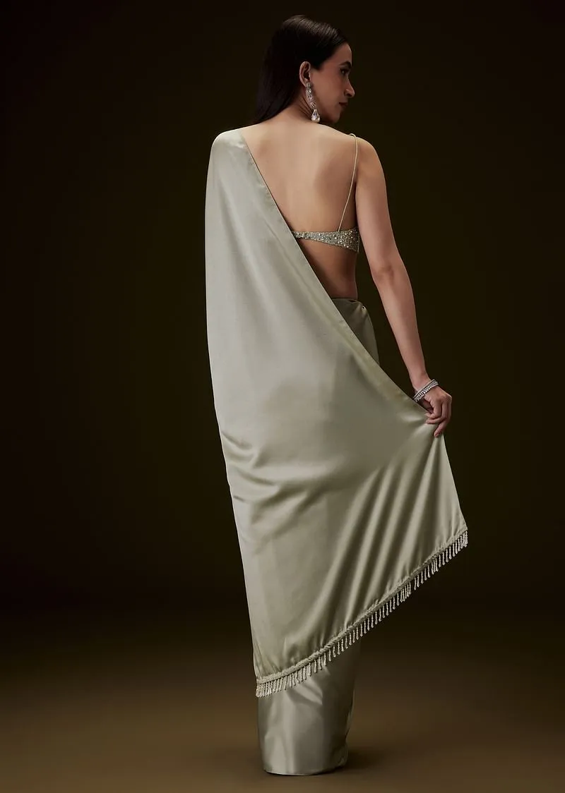 Mint Green Saree With Tassel Embellished Pallu And Deep V Neck Sleeveless Blouse