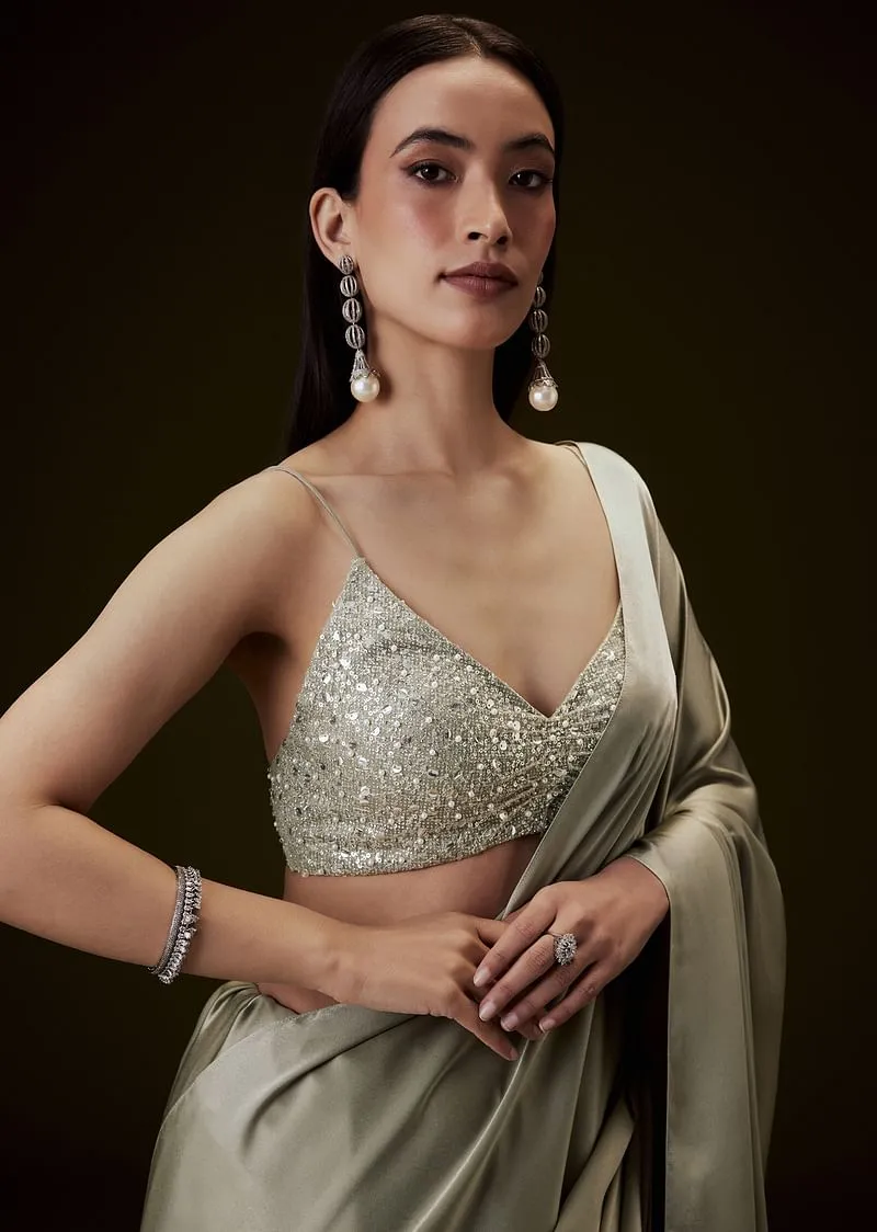 Mint Green Saree With Tassel Embellished Pallu And Deep V Neck Sleeveless Blouse